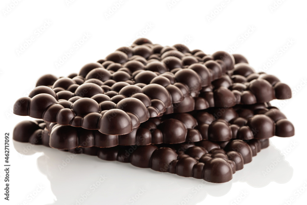 Obraz premium Black raw chocolate stack of bars on a white background. Isolate.