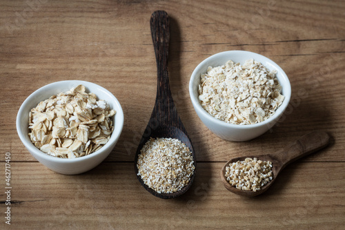 Two variations of oat flakes, oat bran and steel-cut oats photo