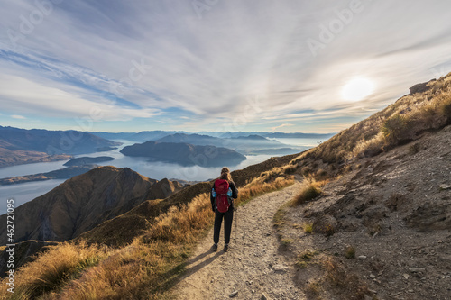 Woman hiking at Roys Peak, Lake Wanaka, New Zealand photo