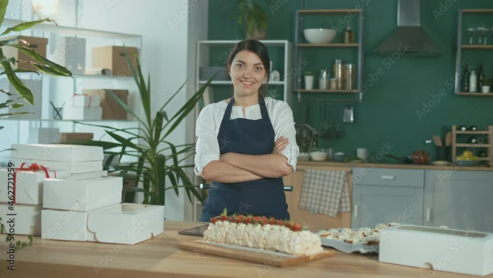 Portrait of a Happy Pastry Chef. Successful Beautiful Businesswoman. Cozy Designer Kitchen Interior. Confectionery and Small Business Concept. Startup. Portrait of a Happy Pastry Chef. Successful Beautiful Businesswoman. Cozy Designer Kitchen Interior. Confectionery and Small Business Concept. Startup.