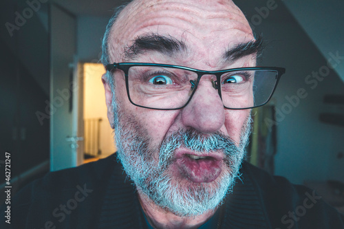 Portrait of grimacing senior man