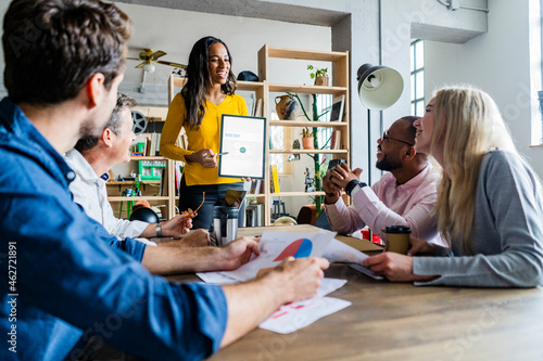 Smiling businesswoman leading a presentation in loft office
