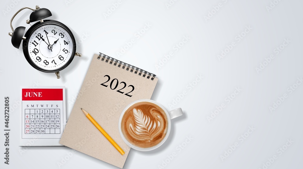 Calendar 2022 and alarm clock on office table. plan for next year. Calendar 2022 and alarm clock on office table. plan for next year.