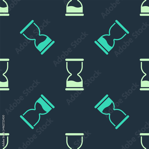 Green and beige Old hourglass with flowing sand icon isolated seamless pattern on blue background. Sand clock sign. Business and time management concept. Vector