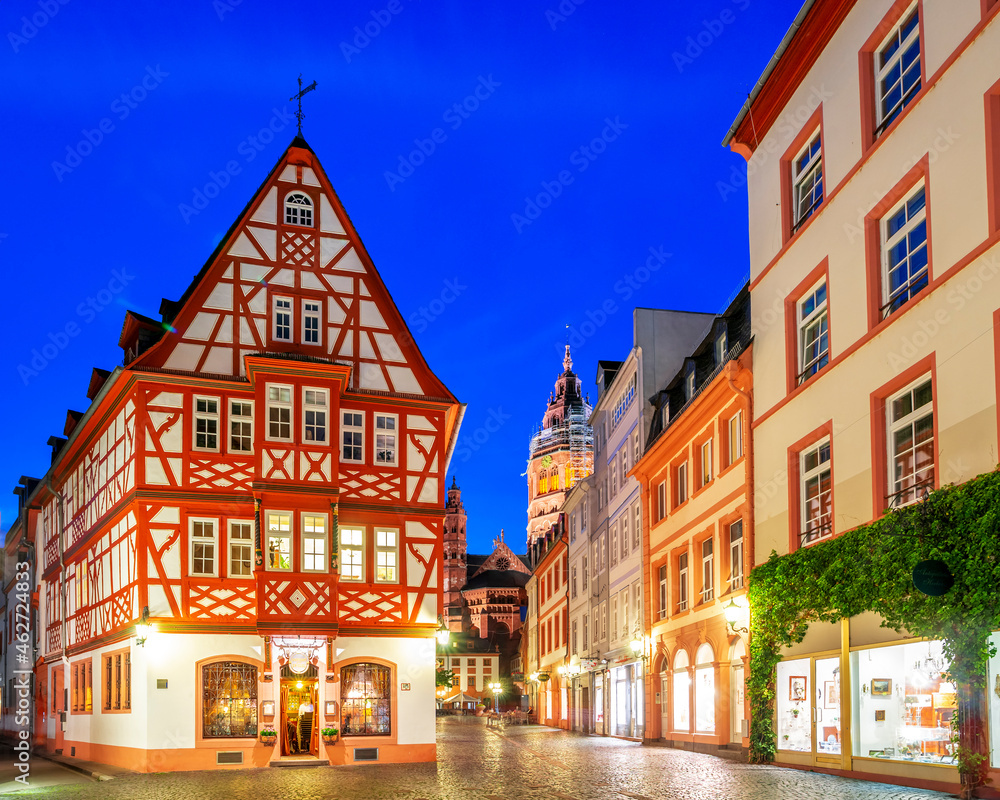 Germany, Rhineland-Palatinate, Mainz, Half-timbered house and illuminated old town street at night Germany, Rhineland-Palatinate, Mainz, Half-timbered house and illuminated old town street at night
