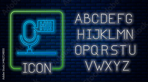 Glowing neon Microphone voice device icon isolated on brick wall background. Microphone interpreter and alphabet letters. Neon light alphabet. Vector