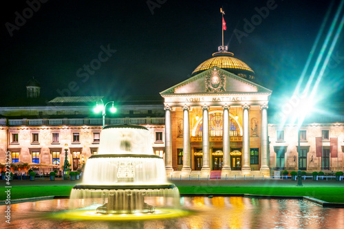 Germany, Hesse, Wiesbaden, Fountain in front of illuminatedÔøΩKurhausÔøΩat night photo