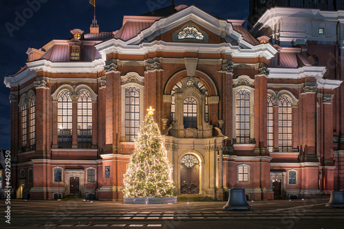 Germany, Hamburg, Christmas tree glowing in front of Saint Michaels Church at night photo