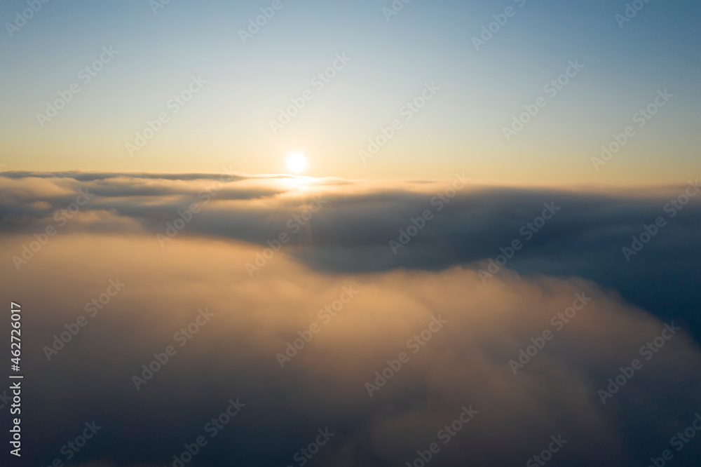 Drone view of sun rising over thick fog Drone view of sun rising over thick fog