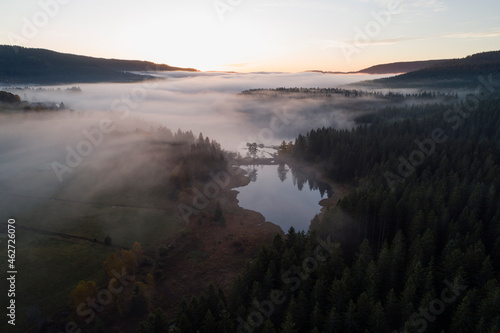 Germany, Baden-Wurttemberg, Drone view ofÔøΩSchluchseeÔøΩlake shrouded in thick fog at sunrise