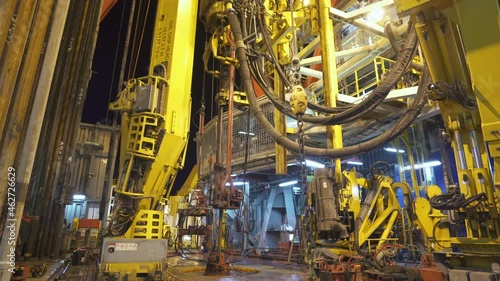 Drilling platform. Rig floor. Rotary table of rig. Top drive goes down with pipe.