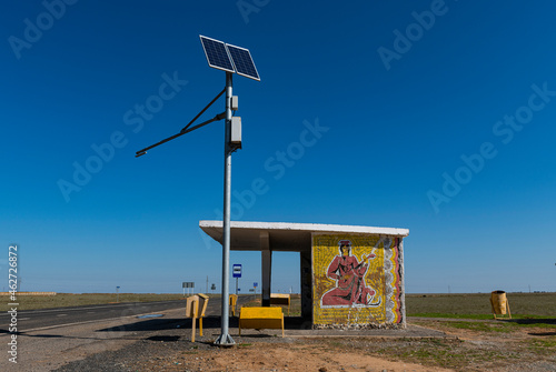 Russia, Republic of Kalmykia, Solar panels in front of remote bus stop photo