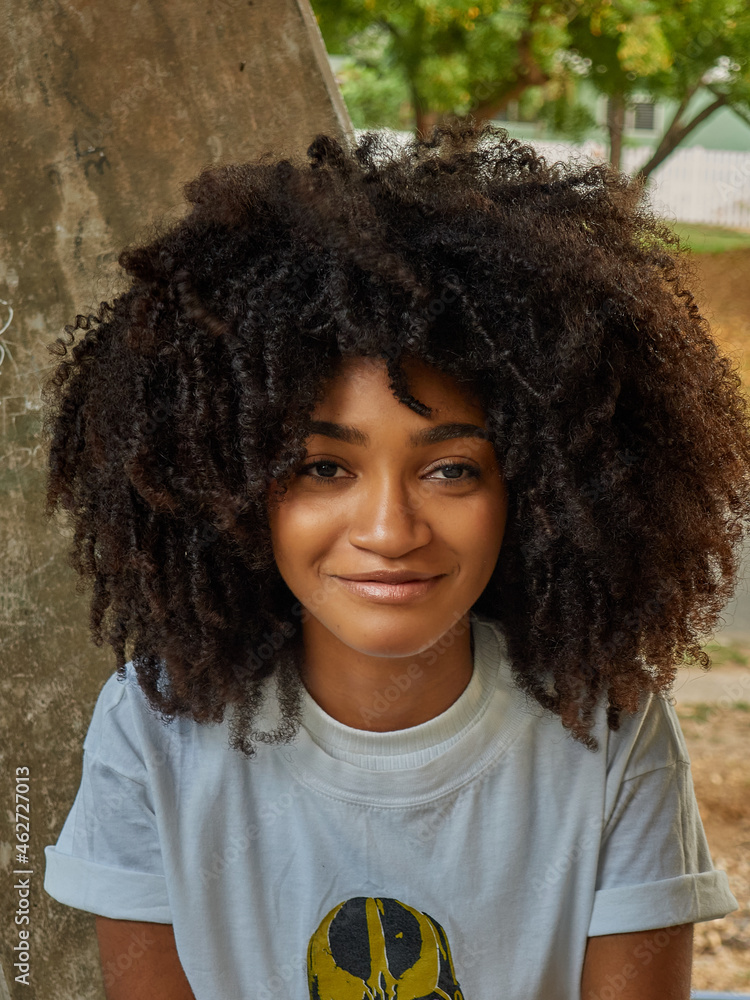 Little girl enjoying nature in Central Park and smiling with her cute hair and smiling