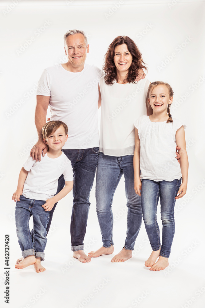 Portrait of happy family with two children standing in front of white background Portrait of happy family with two children standing in front of white background