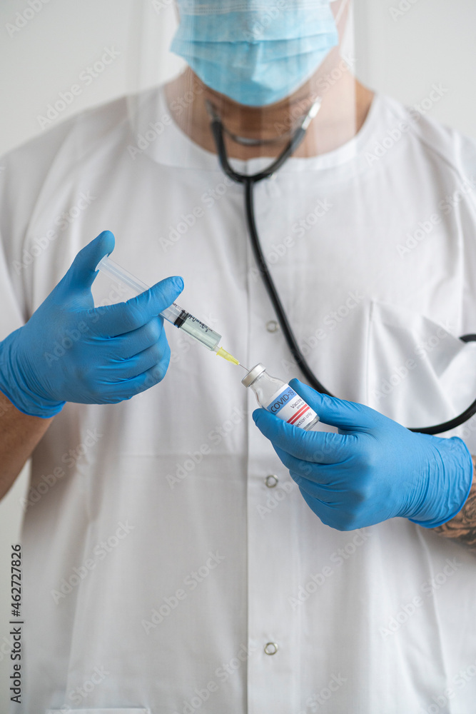 Man in protective wear preparing covid-19 vaccination Man in protective wear preparing covid-19 vaccination