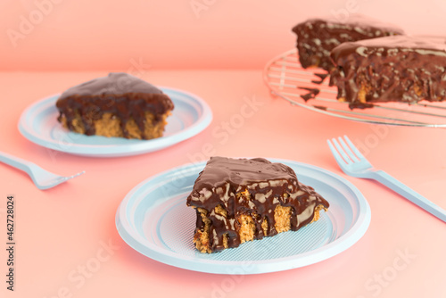 Studio shot of slice of chocolate cake on plastic plate photo