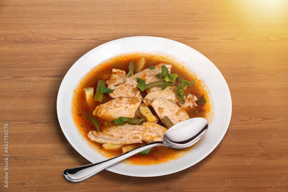Soup dish with beef and vegetables on a plate on the desk Soup dish with beef and vegetables on a plate on the desk