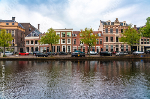 Netherlands, North Holland, Haarlem, Parked cars and historic houses along Binnen Sparne canal photo