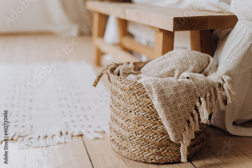 beige plaid on the bedroom floor in a wicker basket