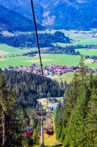 Austria, Tyrol, Gran, Ski lift inÔøΩTannheimerÔøΩTalÔøΩwith village in background photo