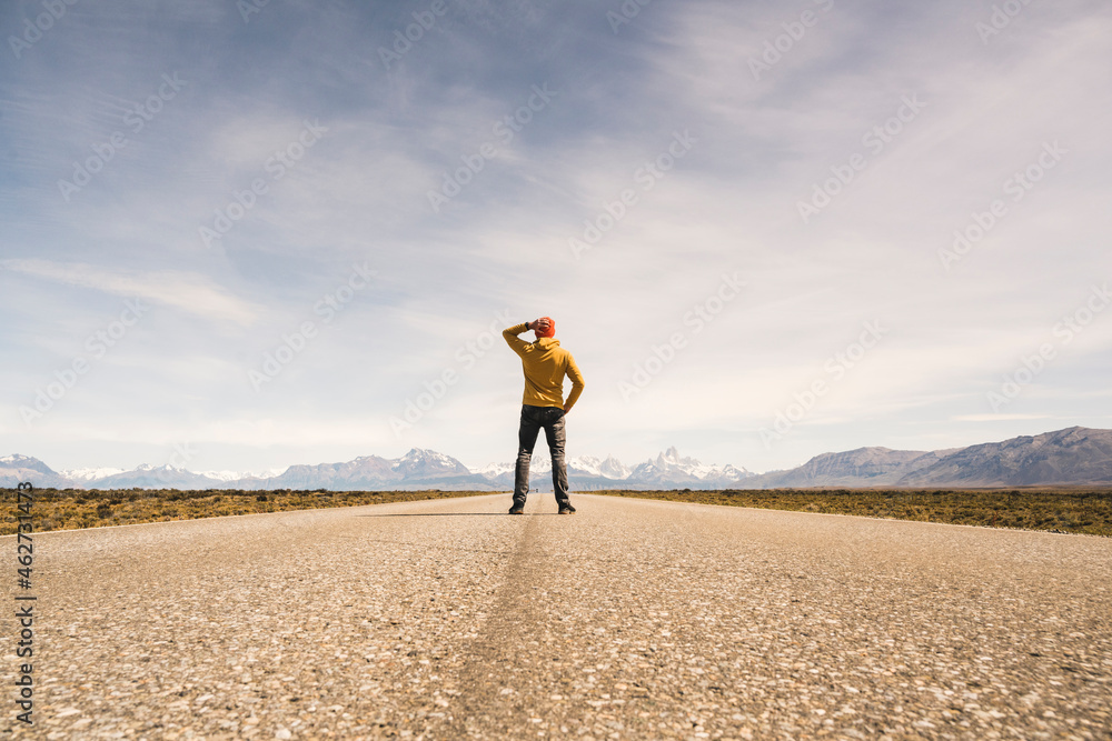 Man standing on a road in remote landscape in Patagonia, Argentina Man standing on a road in remote landscape in Patagonia, Argentina