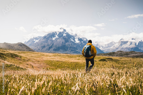Man with backpack exploring Torres Del Paine National Park in Patagonia, South America photo