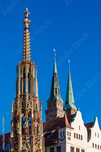 Germany, Bavaria, Nuremberg,ÔøΩSchonerÔøΩBrunnenÔøΩfountains with towers ofÔøΩSaint Sebaldus Church in background photo