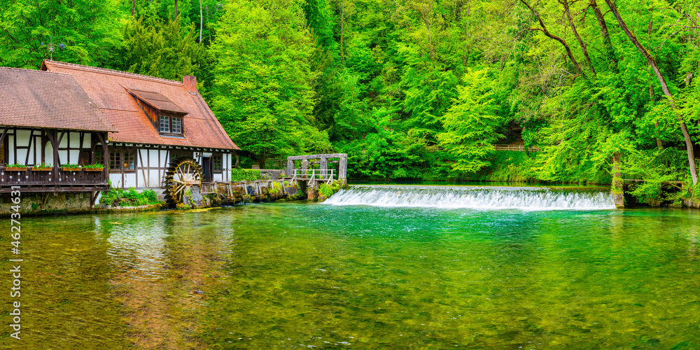 Germany, Baden-Wurttemberg, Blaubeuren, Rustic house on forest riverbank in spring Germany, Baden-Wurttemberg, Blaubeuren, Rustic house on forest riverbank in spring