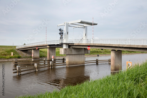 Germany, Lower Saxony, Krummhorn, Bridge over Leyhorner Sieltief river photo