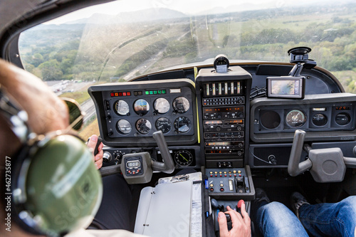 Pilot and copilot navigating sports plane, rear view photo