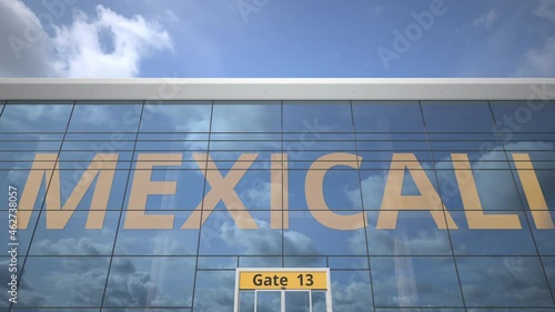 Plane reflects in the airport terminal with MEXICALI city name photo