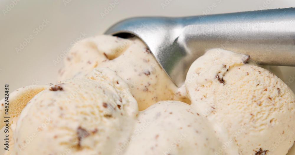 Ice cream Chocolate Chip scooped out from container with a spoon, Close up Food concept.