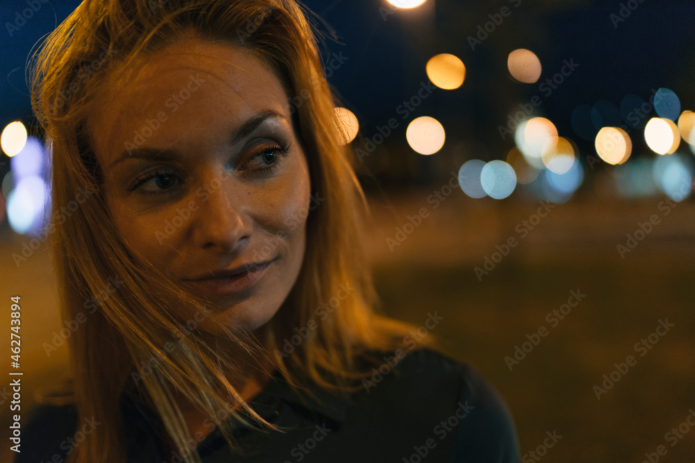 Portrait of young woman in the city at night Portrait of young woman in the city at night
