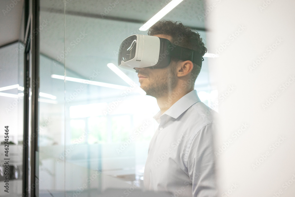 Businessman wearing VR glasses in office Businessman wearing VR glasses in office