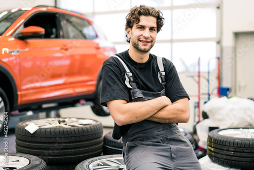 Portrait of a smiling car mechanic in a workshop photo