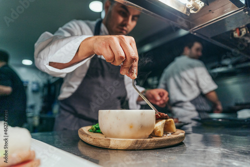 Chef garnishing chopping board with food photo