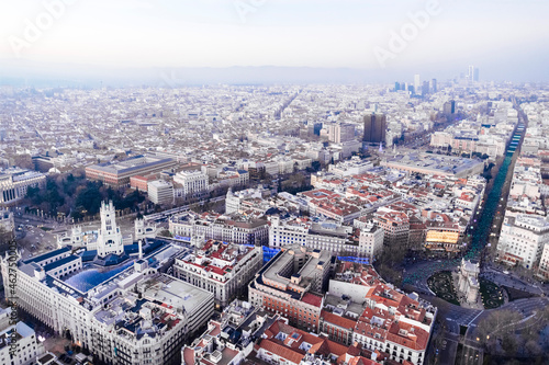 Spain, Madrid, Helicopter view of Puerta de Alcala triumphal arch and surrounding buildings photo