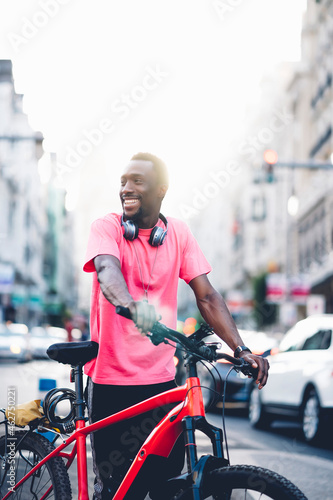 Smiling young man with e bike in the city photo