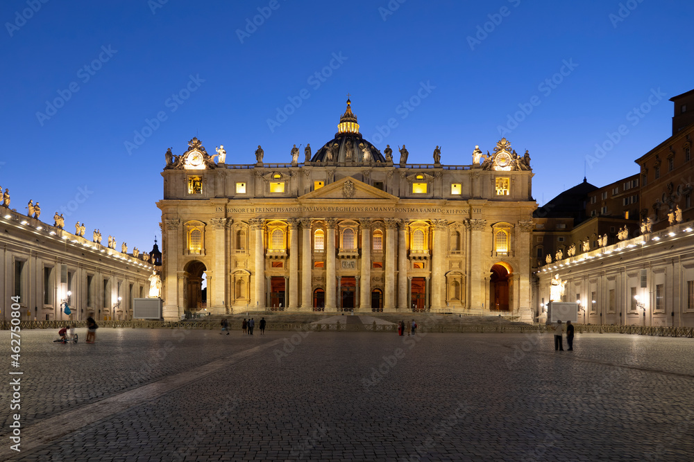 Illuminated facade of St. Peter's Basilica and St. Peter's Square against clear blue sky at dusk, Vatican City, Rome, Italy Illuminated facade of St. Peter's Basilica and St. Peter's Square against clear blue sky at dusk, Vatican City, Rome, Italy