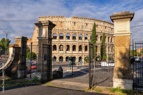Italy, Rome, Colosseum, Oppian Hill Park gate and ancient amphitheatre photo
