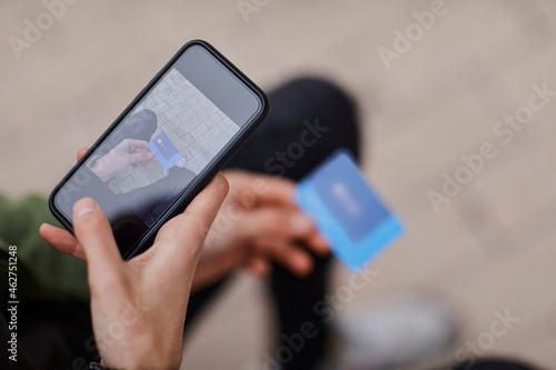 Man taking photo of credit card through smart phone photo