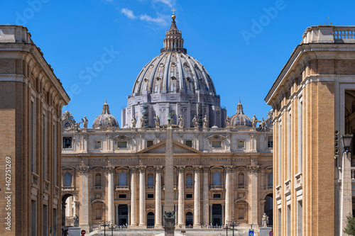 St. Peter's Basilica in city against blue sky on sunny day