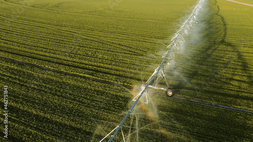 Aerial view of agricultural sprinkler spraying field