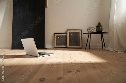 Laptop on wooden floor in a modern room