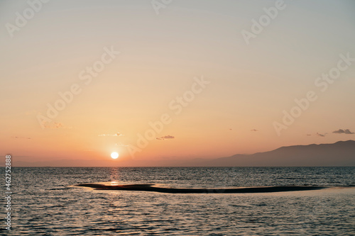 Sunset over Ebro Delta and Platja del Trabucador beach photo