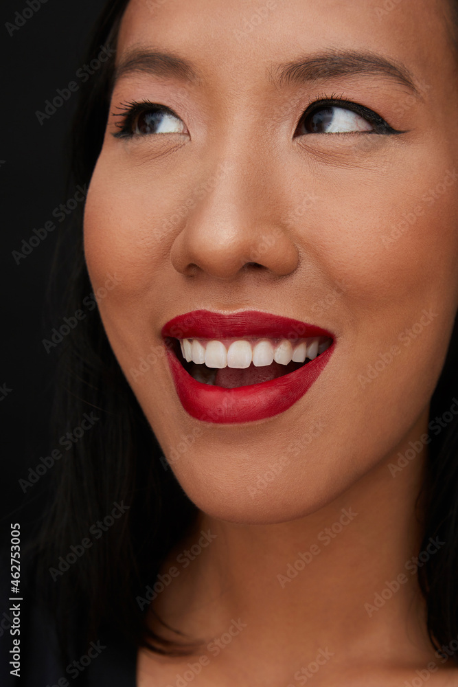 Portrait of young female Chinese woman with red lips, looking up Portrait of young female Chinese woman with red lips, looking up