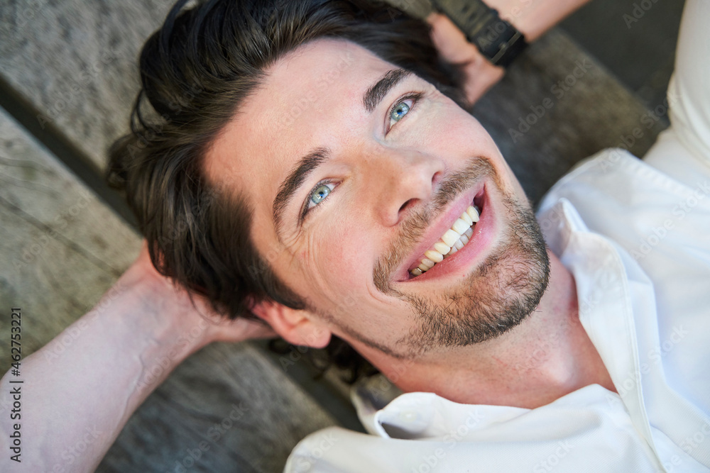 Portrait of happy businessman lying on a bench Portrait of happy businessman lying on a bench