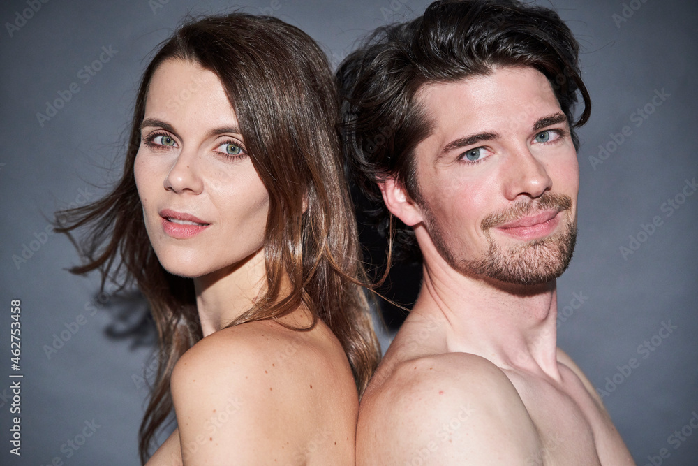 Portrait of nude couple back to back