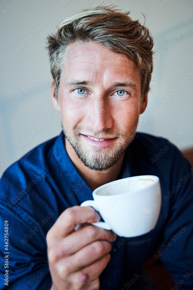 Portrait of young man holding cup of coffee Portrait of young man holding cup of coffee