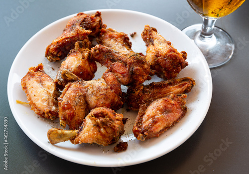 Plate with spicy barbecue chicken wings, homemade appetizer